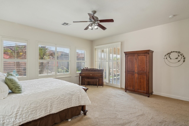 bedroom featuring ceiling fan and light carpet