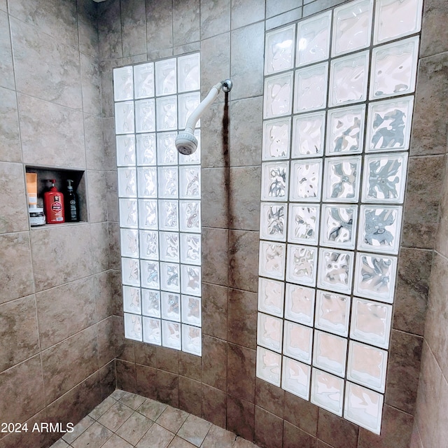 bathroom featuring a tile shower and tile patterned floors