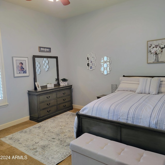 bedroom featuring ceiling fan and light colored carpet