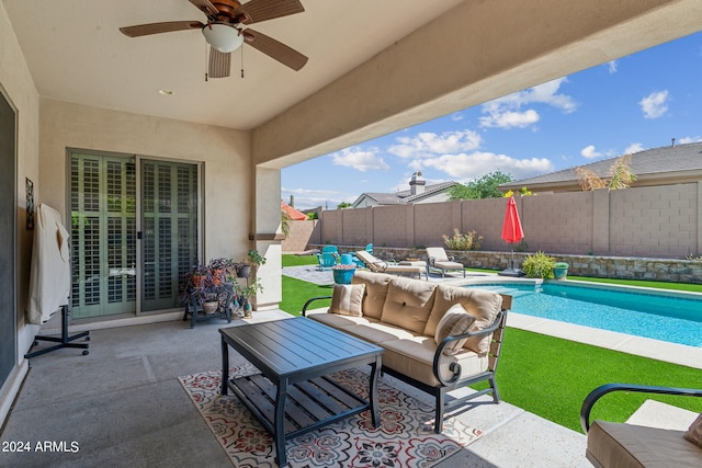 view of patio / terrace featuring a fenced in pool, ceiling fan, and outdoor lounge area