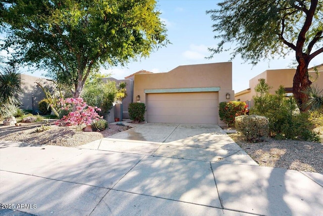 pueblo-style home featuring a garage