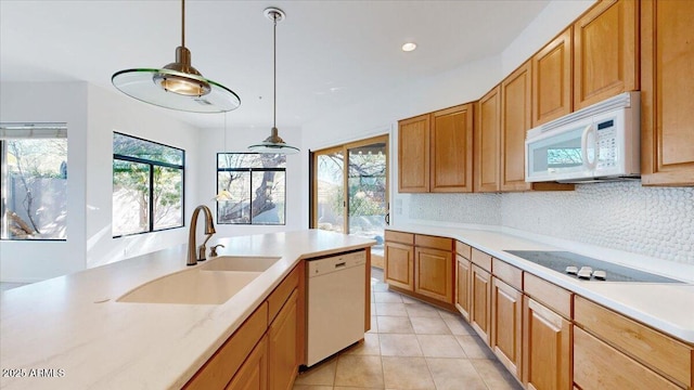 kitchen featuring decorative light fixtures, sink, decorative backsplash, light tile patterned floors, and white appliances