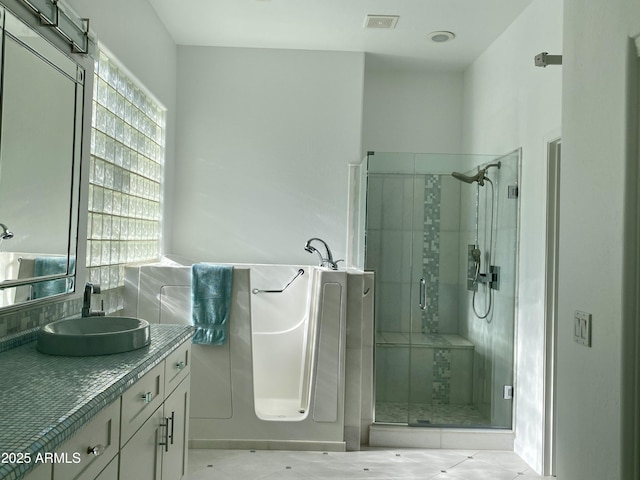 bathroom with walk in shower and vanity