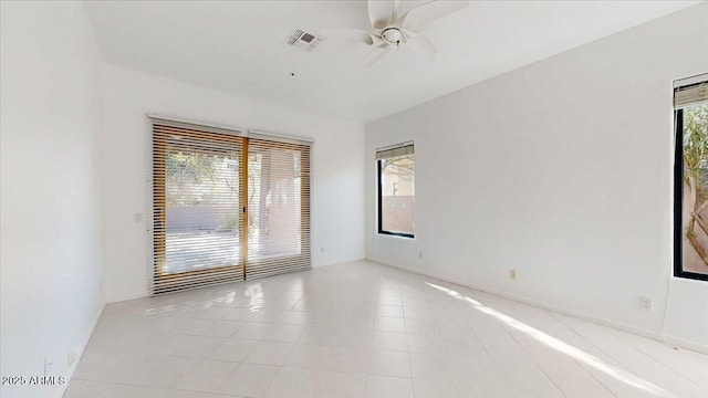 spare room featuring light tile patterned floors and ceiling fan