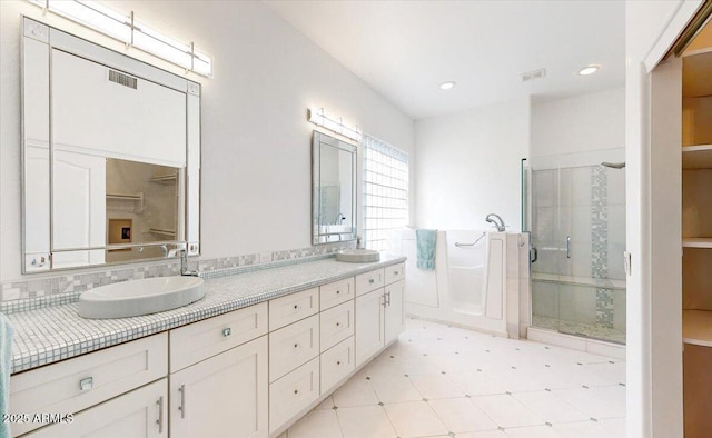 bathroom with independent shower and bath and vanity