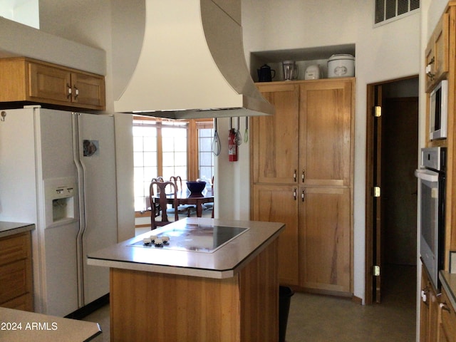 kitchen with white fridge with ice dispenser, custom range hood, a kitchen island, black electric cooktop, and stainless steel oven