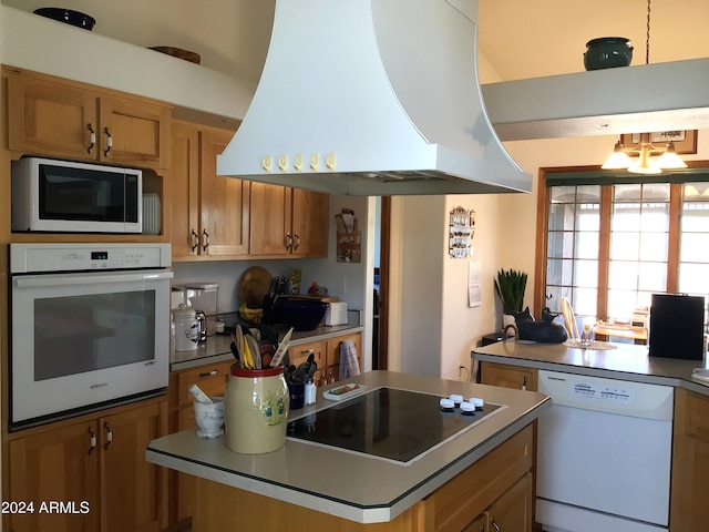 kitchen featuring island exhaust hood, a center island, and white appliances