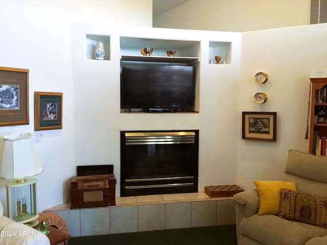 living room with a tile fireplace