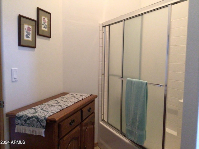 bathroom with shower / bath combination with glass door