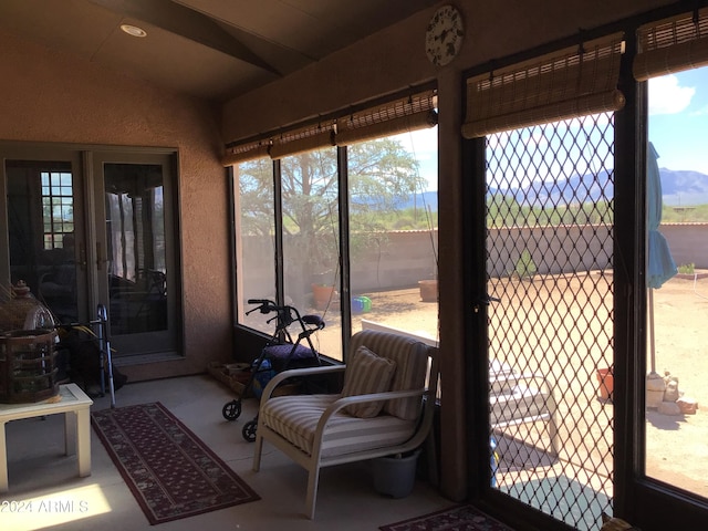 sunroom featuring lofted ceiling