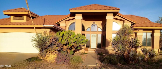 mediterranean / spanish home with a garage