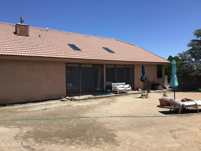 back of property with a patio