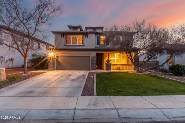 view of front of house featuring a yard and a garage