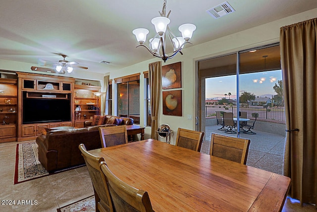 dining area with ceiling fan with notable chandelier