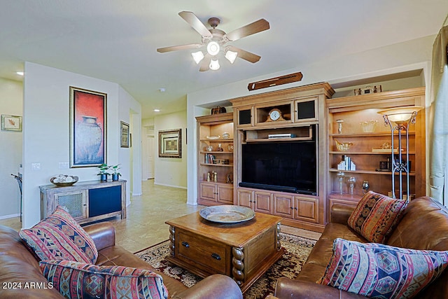 living room with built in shelves and ceiling fan