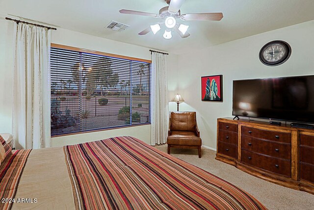 bedroom with ceiling fan and light carpet