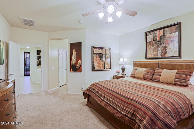 bedroom with light colored carpet and ceiling fan