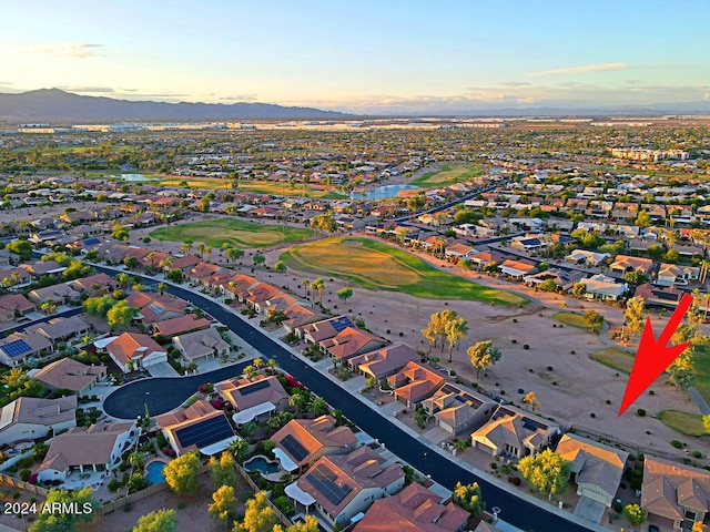 aerial view at dusk featuring a mountain view