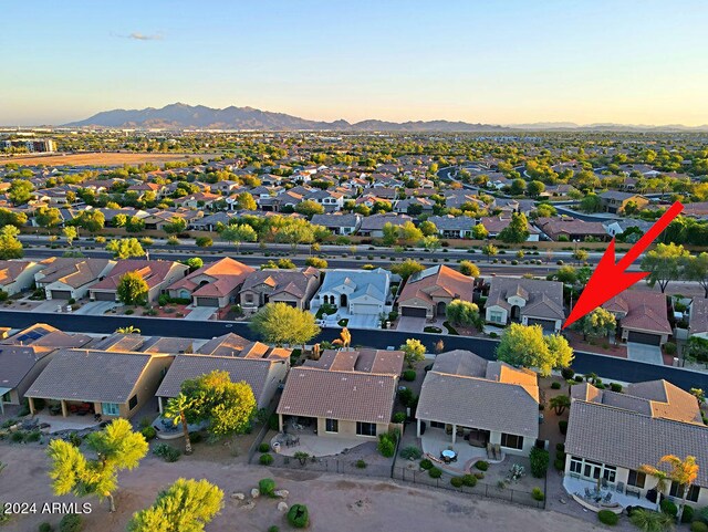 aerial view at dusk featuring a mountain view