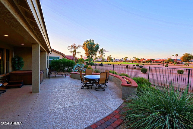 view of patio terrace at dusk