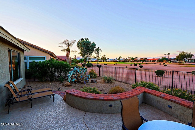 view of patio terrace at dusk