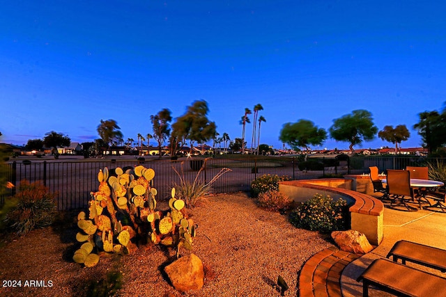 yard at dusk with a patio area