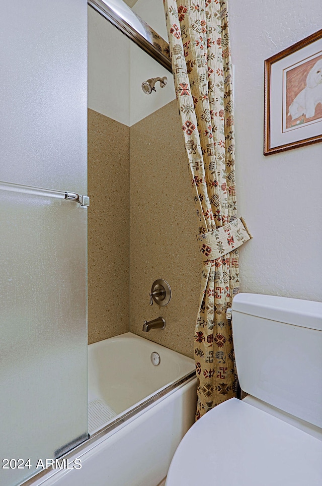 bathroom with shower / tub combo and toilet