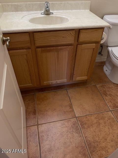 bathroom featuring tile patterned floors, toilet, and vanity