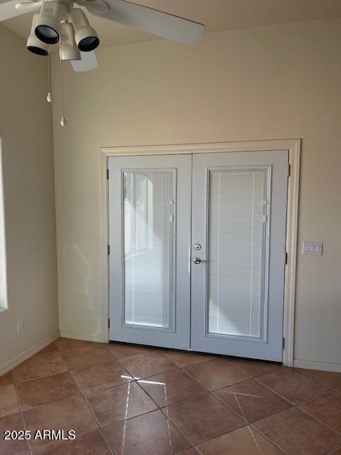 doorway with tile patterned floors, french doors, baseboards, and a ceiling fan