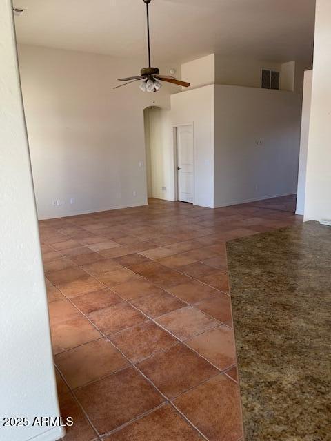 tiled empty room with visible vents and ceiling fan