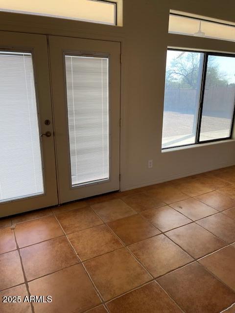 doorway to outside with french doors and tile patterned flooring