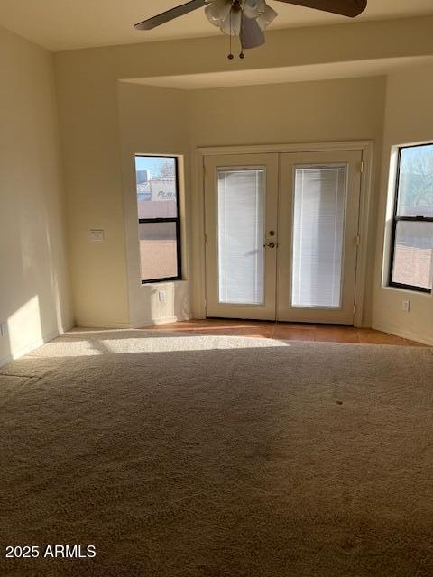 spare room with french doors and a ceiling fan