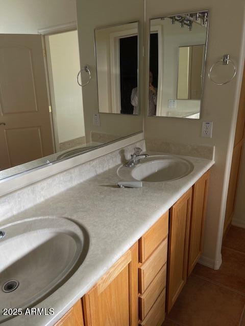 full bathroom featuring tile patterned flooring, double vanity, and a sink