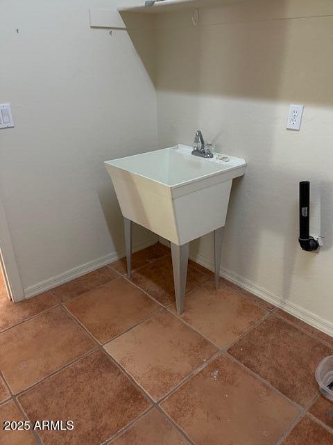 interior space with tile patterned floors and baseboards