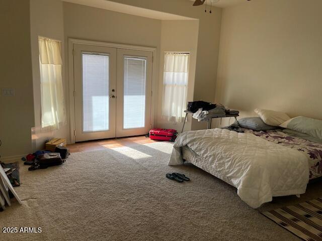 bedroom featuring access to exterior, french doors, a ceiling fan, and carpet