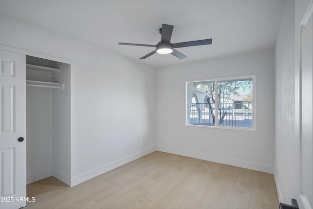 unfurnished bedroom with light hardwood / wood-style flooring, a closet, and ceiling fan