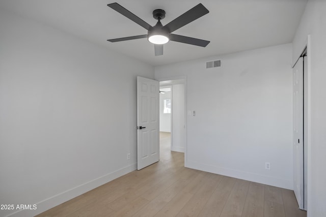 unfurnished bedroom with ceiling fan, a closet, and light hardwood / wood-style flooring