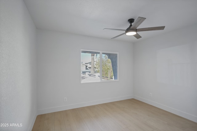 spare room with light hardwood / wood-style floors and ceiling fan