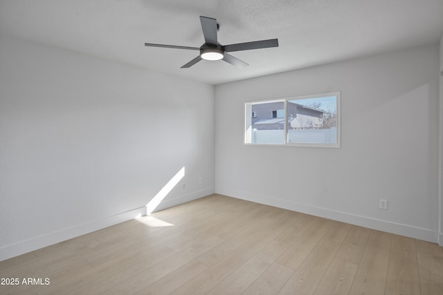 unfurnished room with ceiling fan and light wood-type flooring