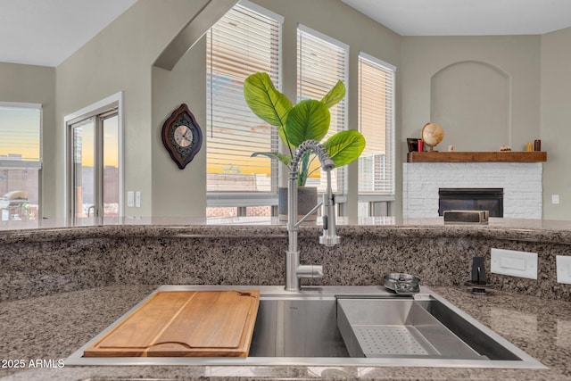 room details with a brick fireplace and stone counters