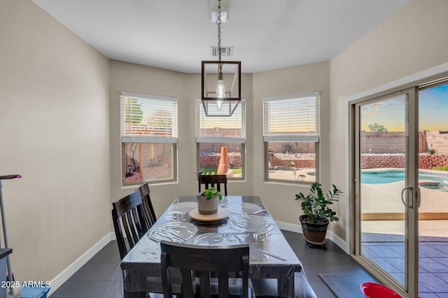 dining room featuring visible vents and baseboards