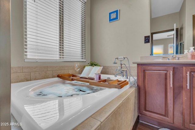 full bathroom with a bath and vanity