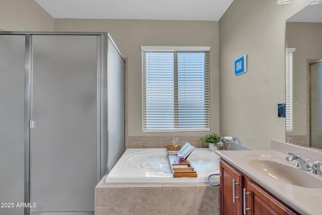 full bath featuring a stall shower, vanity, and a garden tub