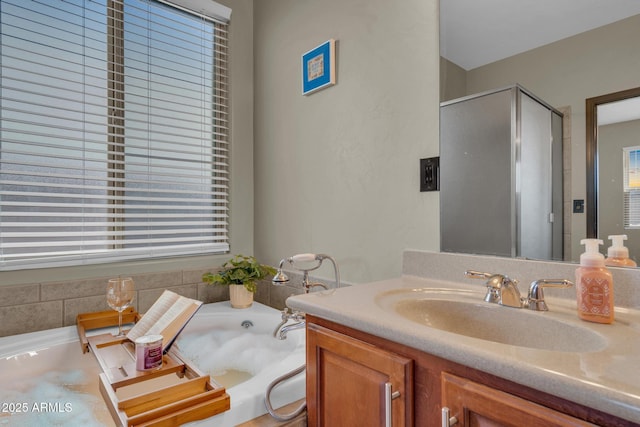 bathroom featuring a garden tub, vanity, and a stall shower