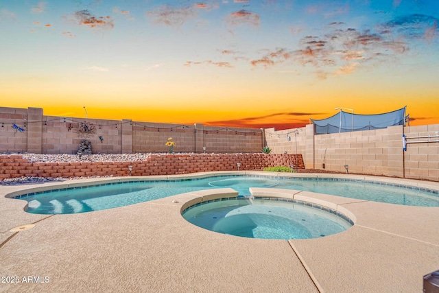 view of pool featuring an in ground hot tub, a fenced in pool, and a fenced backyard