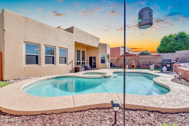 view of swimming pool featuring a fenced backyard, grilling area, a patio area, and a pool with connected hot tub