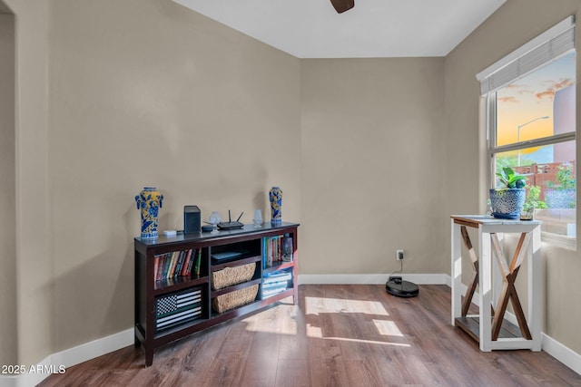 miscellaneous room with wood finished floors, baseboards, and ceiling fan
