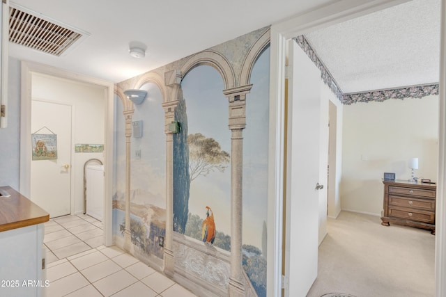 hall with light tile patterned floors