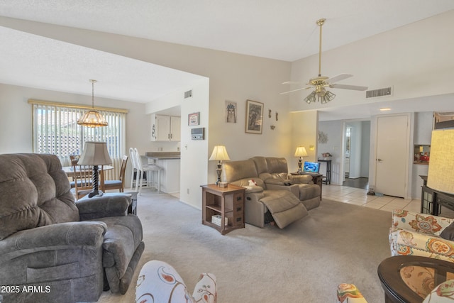 living room with light colored carpet and ceiling fan