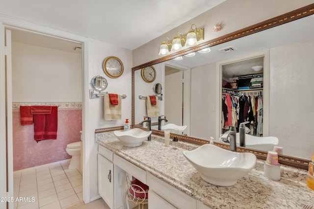 bathroom featuring tile patterned floors, vanity, and toilet